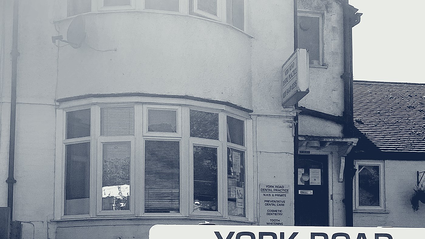 York Road Dental Practice seen across its front garden from the pavement.