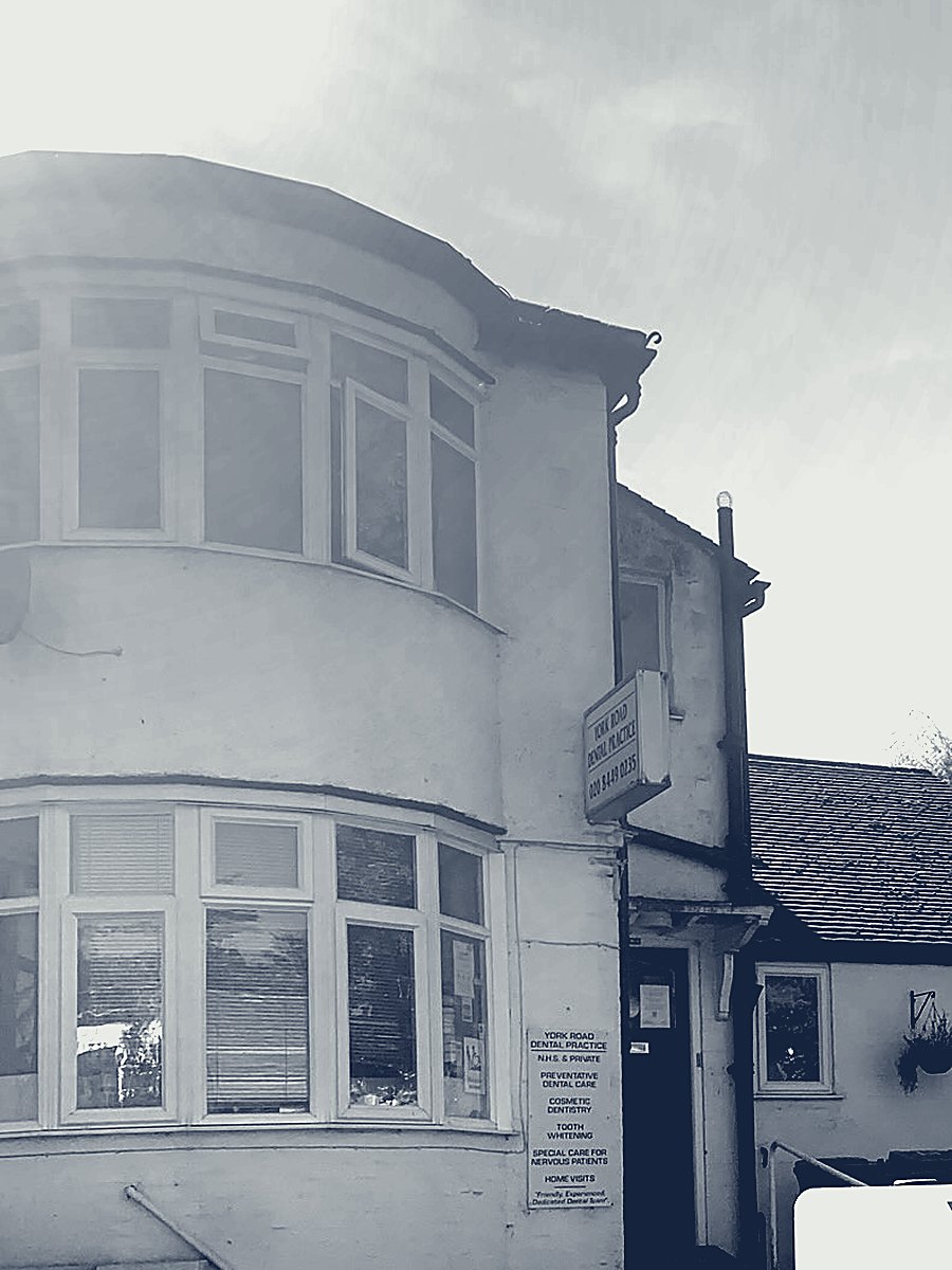 The front of York Road Dental Practice: a white bay-windowed house with the practice sign beside the door.
